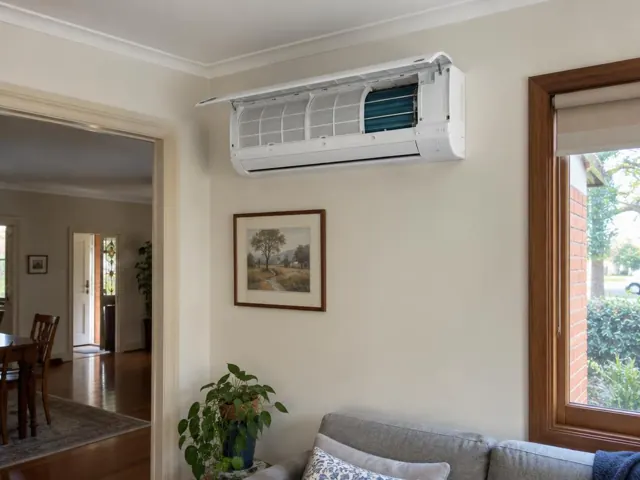 Clean split system indoor unit on a beige wall with open front panel and visible filters in a living room in Blackwood